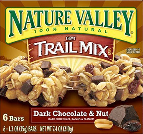Packaging for Nature Valley Chewy Trail Mix Dark Chocolate & Nut, featuring the bar with chocolate chunks and peanuts, and the text highlighting the flavors and nutritional information.